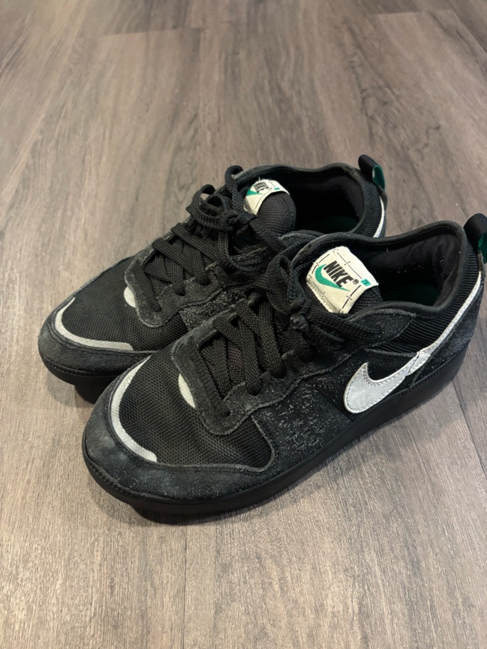 Nike Black Low-Top Sneakers with White Swoosh and Teal Tongue Accent